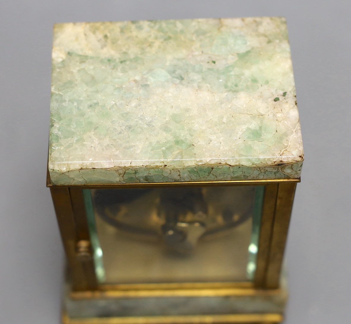 A French onyx and brass small mantel clock, with ornate enamel dial,14.5cms high